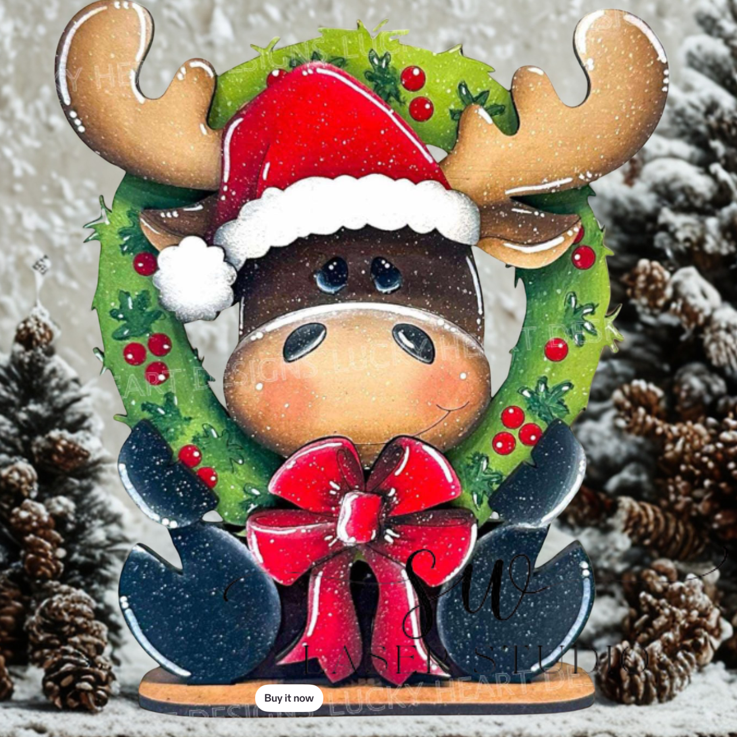 Decorative moose figurine with a Santa hat, wreath, and red bow on a snowy background.